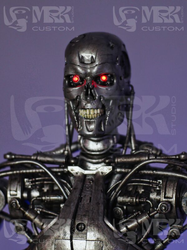 Close-up of hand-painted Terminator T-800 head with detailed sculpting and LED lighting.