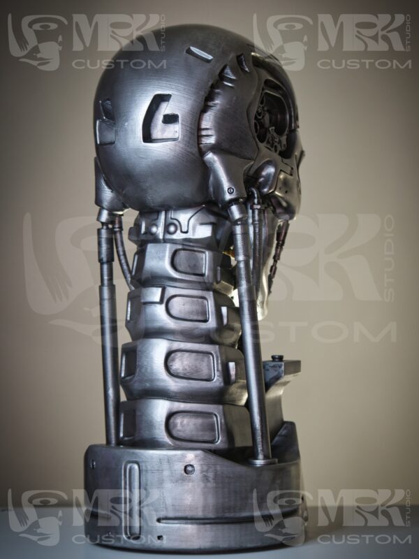1:1 scale Terminator T-800 head statue with glowing red LED eyes and metallic detailing.
