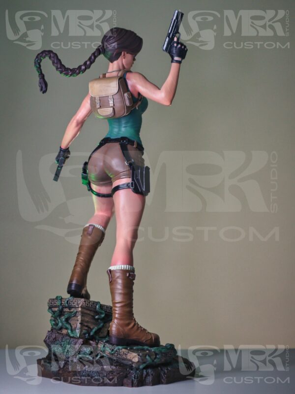Back angle of Lara Croft statue with braided hair and textured base, part of detailed Tomb Raider sculpture.